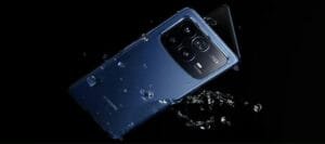Xiaomi 17 Fold or Xiaomi Mix Fold 5 foldable smartphone in blue finish with Leica camera module, surrounded by water droplets against a black background