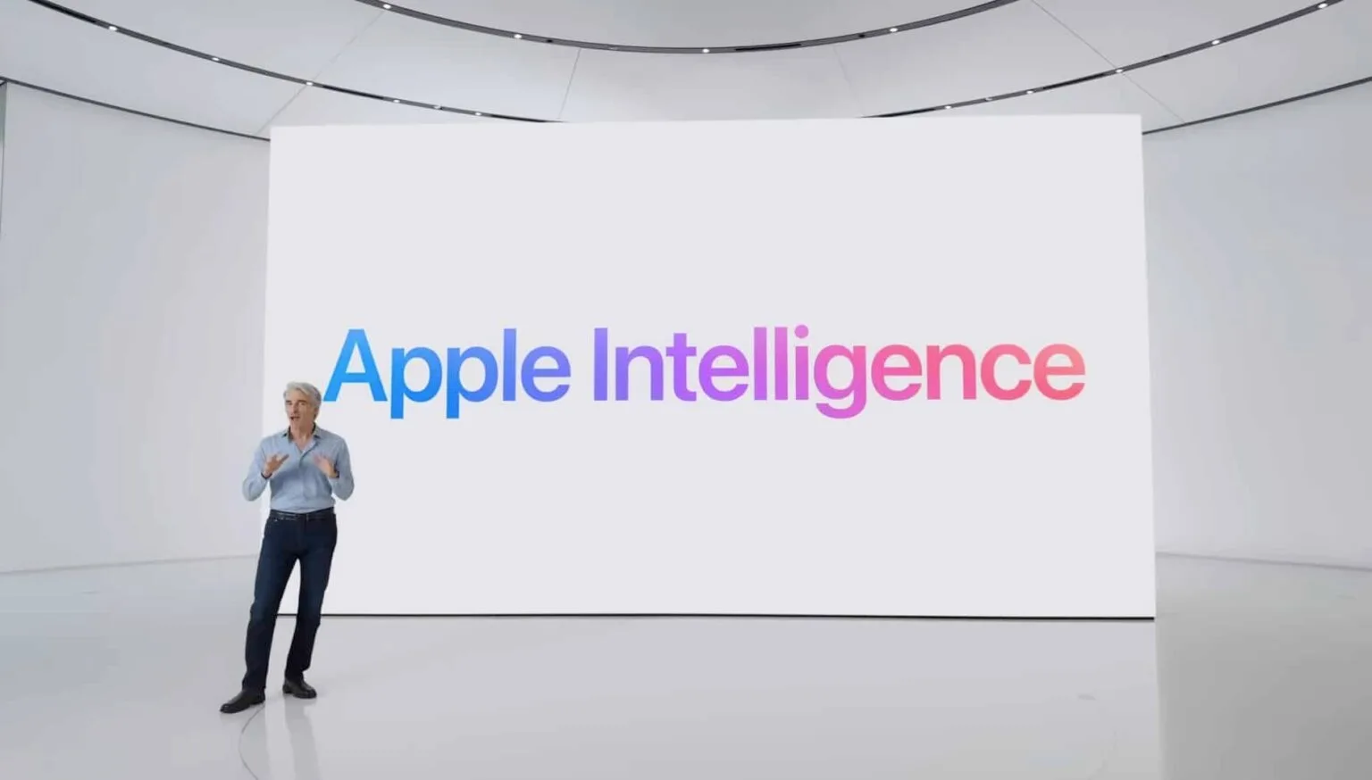 Apple executive presenting Apple Intelligence on large display during product launch event