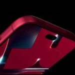 iPhone 18 Pro New Leak with Dark Cherry Color and Further Spec Details 1 Close-up side view of the Apple iPhone 18 Pro in Dark Cherry finish, showing its glossy red back panel, rear camera cutout, and side buttons against a dark background.
