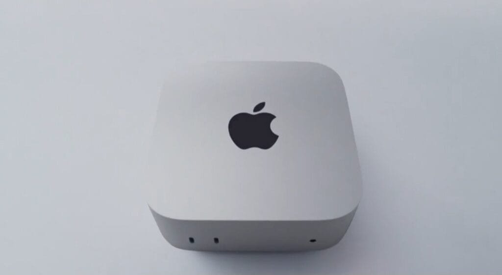 Apple Unveils New M6 Mac Mini With 2nm Chip Built for Local AI Apple Mac Mini with M6 chip, compact silver desktop device with Apple logo on top and front-facing ports