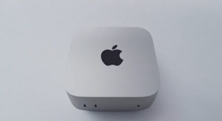 Apple Unveils New M6 Mac Mini With 2nm Chip Built for Local AI Apple Mac Mini with M6 chip, compact silver desktop device with Apple logo on top and front-facing ports