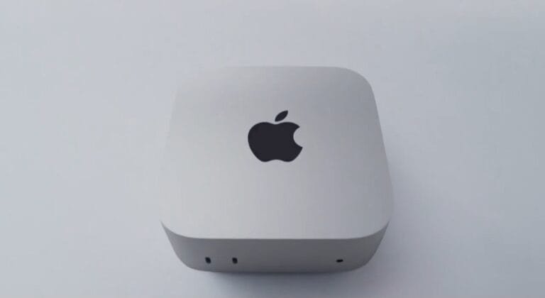 Apple Mac Mini with M6 chip, compact silver desktop device with Apple logo on top and front-facing ports