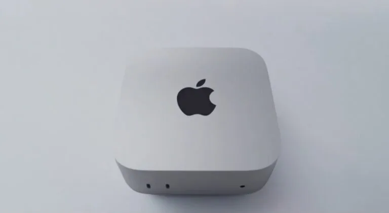 Apple Mac Mini with M6 chip, compact silver desktop device with Apple logo on top and front-facing ports