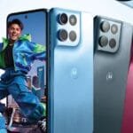 Promotional banner for the Motorola Moto G Max showing three rear panels in Blue, Gray, and Pink satin finishes with square camera modules and Motorola logo, alongside the front display with punch-hole camera. Colorful design set against a light blue backdrop with flowing fabric accents.