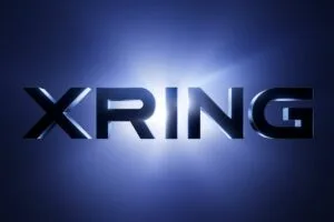 XRING logo in bold metallic 3D lettering set against a glowing deep blue gradient background with a bright light flare behind the text.
