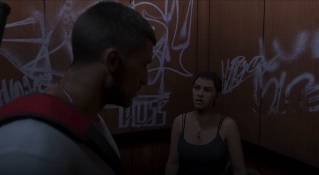 GTA 6 Extended Look Released: Everything Shown in the 27-Minute Video 2 GTA 6 Extended Look gameplay cutscene showing protagonists Jason and Lucia facing each other inside a graffiti covered elevator, Leonida story scene.