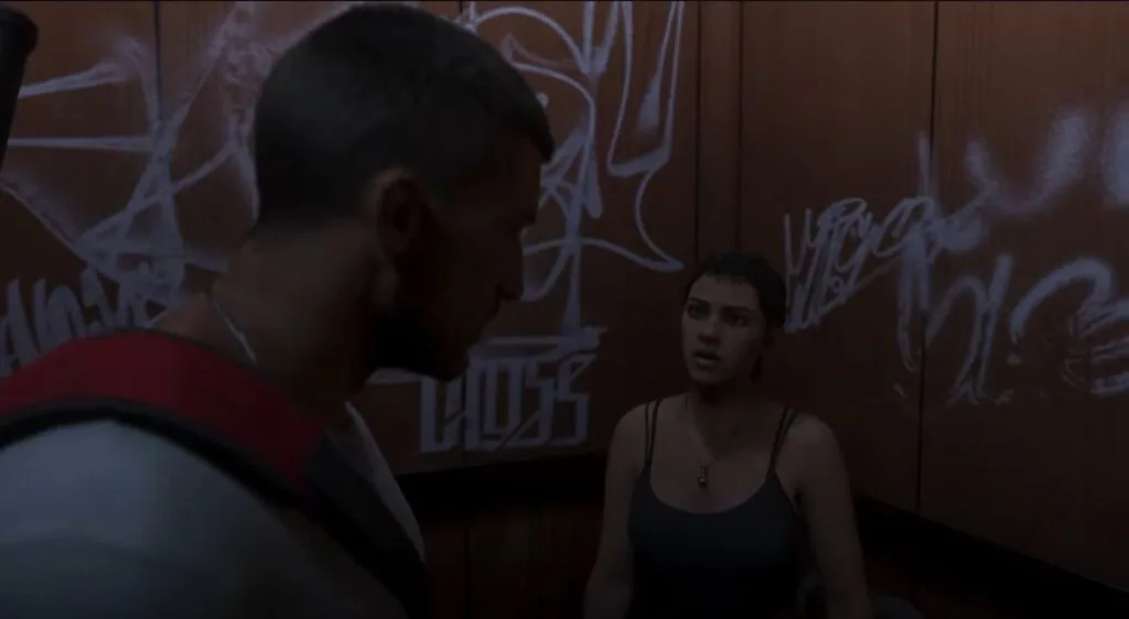 GTA 6 Extended Look Released: Everything Shown in the 27-Minute Video 2 GTA 6 Extended Look gameplay cutscene showing protagonists Jason and Lucia facing each other inside a graffiti covered elevator, Leonida story scene.