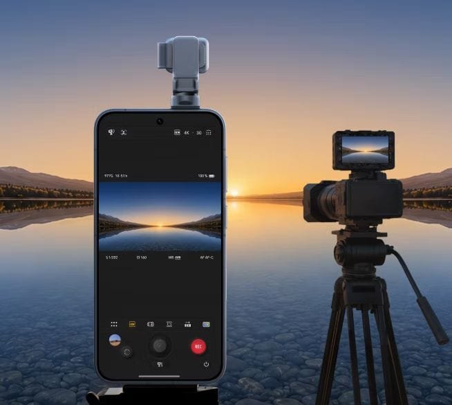 Honor Launches Robot Phone: Swivel Gimbal Camera, Giant Battery, and ARRI Imaging Features 2 Honor Robot Phone with gimbal camera extended, positioned next to a DSLR camera on a tripod, both displaying the same sunset landscape shot to highlight comparable imaging quality.