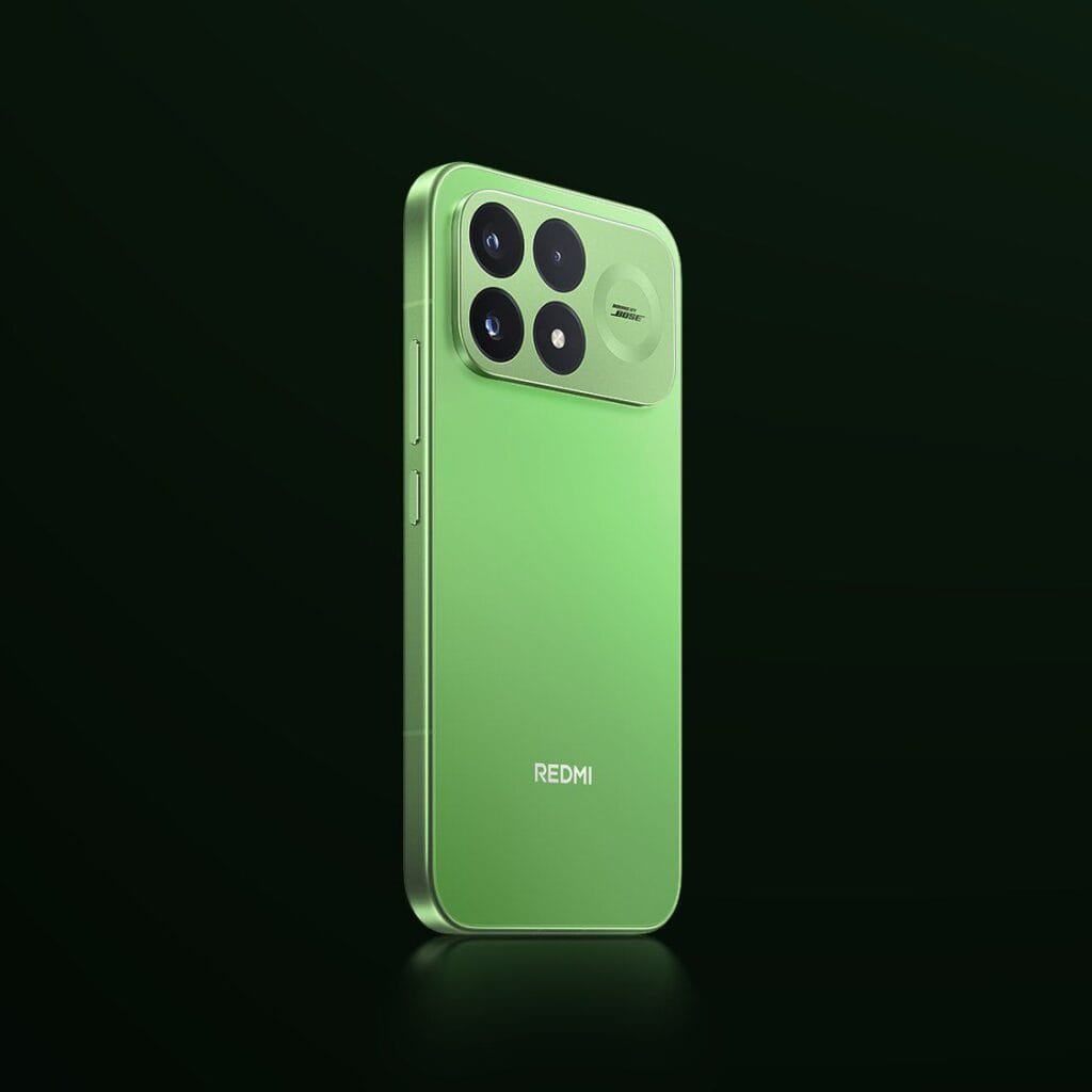 Redmi K100 Pro Glowing Firefly Variant Unveiled 2 A full rear perspective of the Redmi K100 Pro standing upright against a dark background, showcasing its clean, translucent green back panel, flat metallic sides, and a color-matched square camera island on the upper portion of the device.