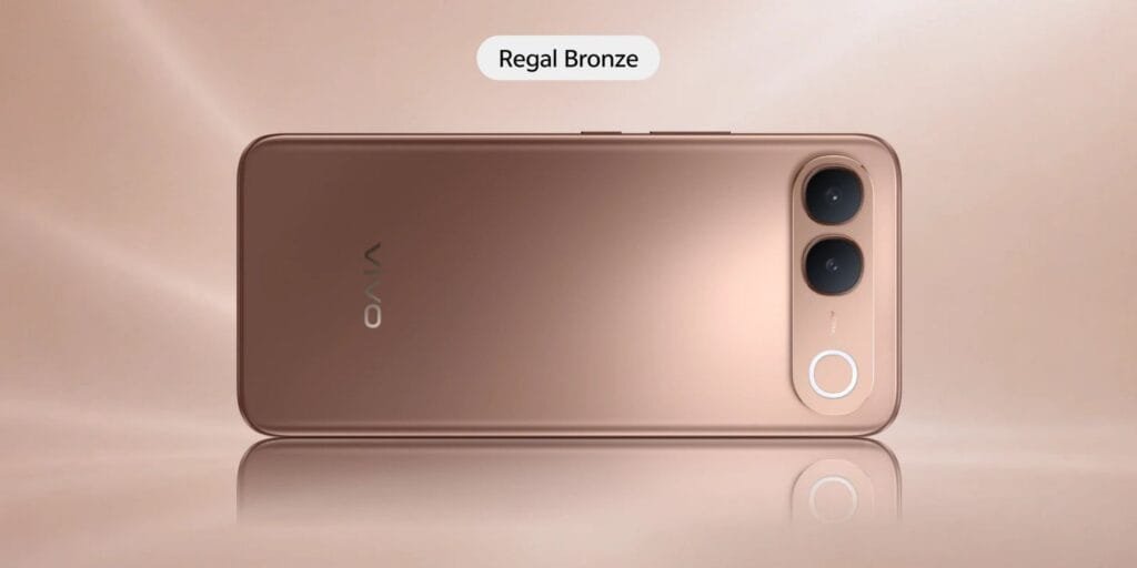 Vivo S2 smartphone viewed from the rear in the Regal Bronze finish, featuring a smooth metallic gold-bronze rear panel, vertical dual-camera module, circular accent ring, and vivo logo against a warm neutral background.