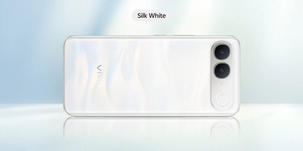 Vivo S2 smartphone viewed from the rear in the Silk White finish, displaying a subtle pearlescent pattern across the back, vertical dual-camera setup, circular accent ring, and vivo logo on a pale white backdrop.