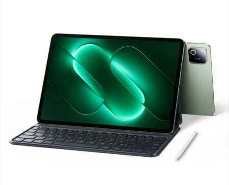 Xiaomi Pad 9 tablet shown with attached magnetic keyboard and stylus beside it. Spruce Green back panel visible with square camera module. Screen displays glowing green abstract design. White background. Official product image.