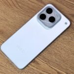 iQOO 16 Global Variant Spotted on Geekbench AI with 16GB of RAM 3 iQOO 16 in white finish showing triangular triple camera module with 100X zoom marking on wood surface