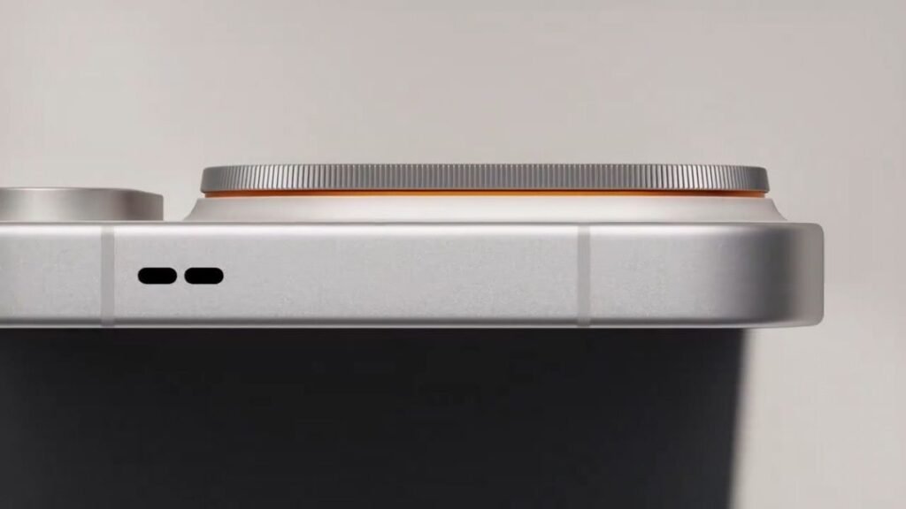 Oppo Just Announced the Find X10 Series Launch Date and Here Are the Details 1 Close up side view of Oppo Find X10 Pro Max frame. Silver metallic finish with two small speaker holes. Orange accent ring around camera module edge. Screenshot by Wazzuptechph from official teaser video.