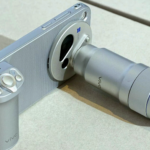 Vivo X500 Pro Max with detachable Zeiss telephoto lens accessory and camera grip, sleek silver metallic finish