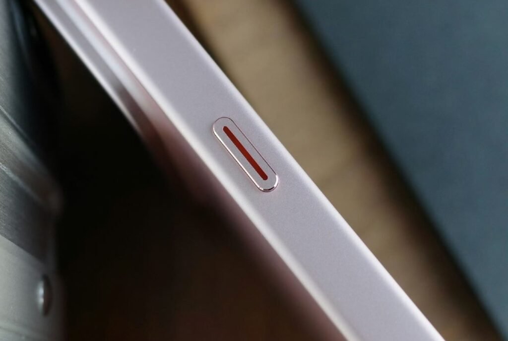 Xiaomi 18 Pro Launched in China with Snapdragon 8 Elite Gen 6, 200MP Periscope, and 7,000mAh Battery 4 Xiaomi 18 Pro side profile, pink frame with red-accented AI button, smooth metallic finish