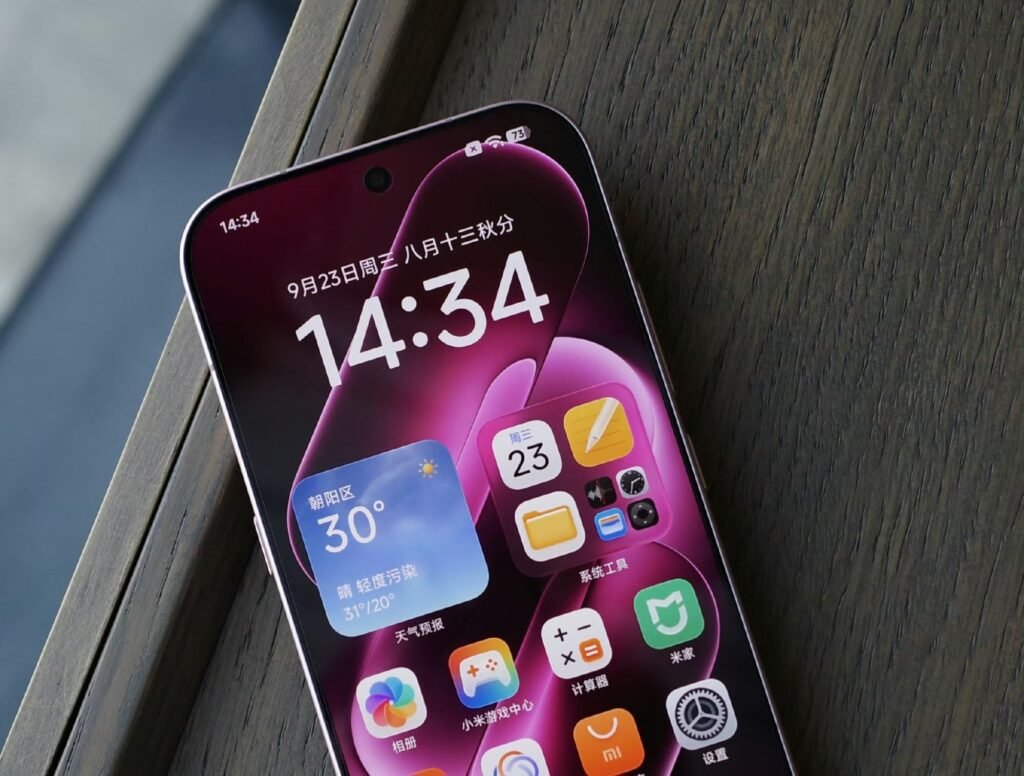 Xiaomi 18 Pro Launched in China with Snapdragon 8 Elite Gen 6, 200MP Periscope, and 7,000mAh Battery 1 Xiaomi 18 Pro front screen showing time, date, weather widget, and app icons on pink gradient display