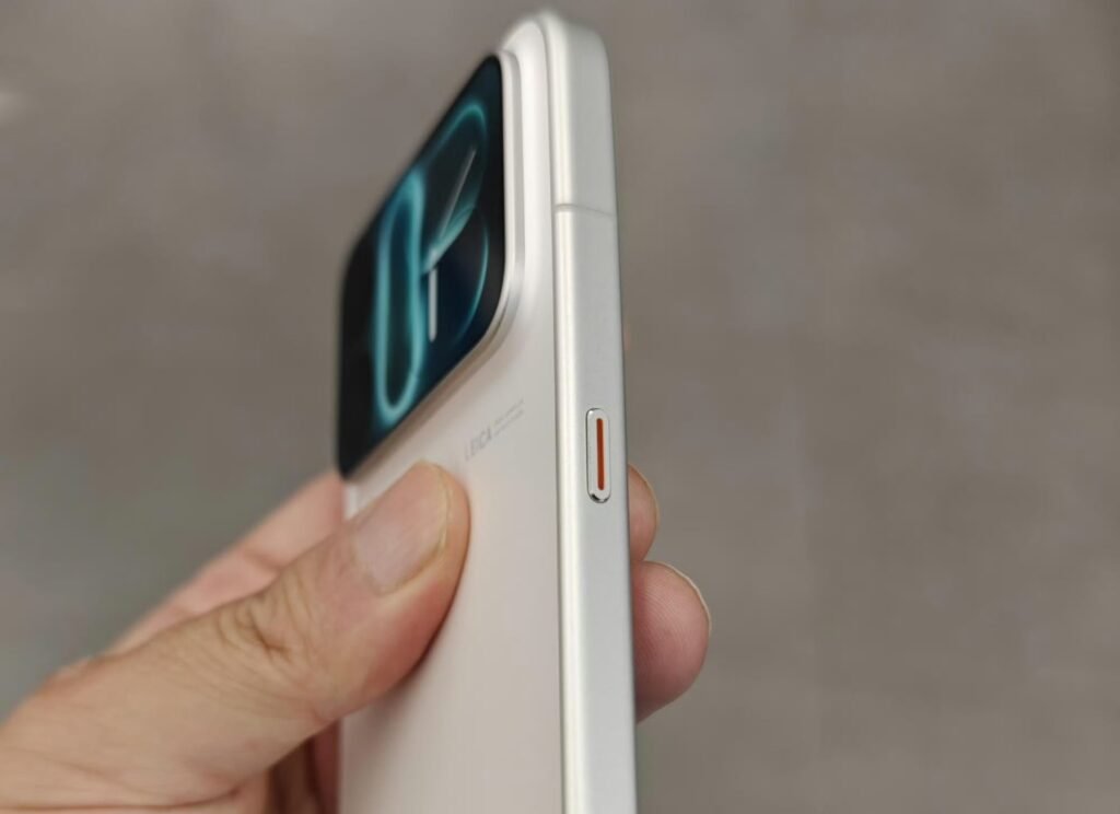 Xiaomi 18 Pro Max Launched in China with Snapdragon 8 Elite Extreme Gen 6, Dual 200MP Cameras and 8,500mAh Battery 3 Xiaomi 18 Pro Max side profile, white body, AI button with orange accent, secondary display visible at top