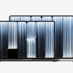 Two Apple MacBook Pro 2026 units in space‑gray and silver finishes, showing their PROLED XRD displays with flowing blue‑white line‑art graphics, set against a plain light‑white background.