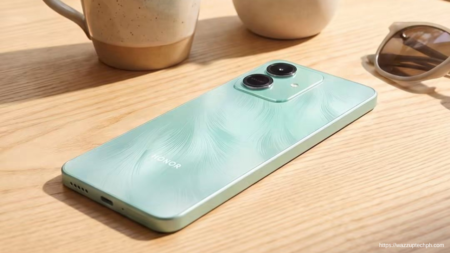 Rear‑angle shot of the light‑green Honor Play10 resting on a wooden table beside ceramic mugs and light‑framed sunglasses