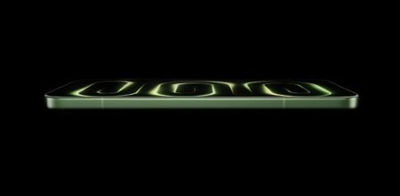Redmi K100 side profile in green finish with glowing neon green design on screen against black background