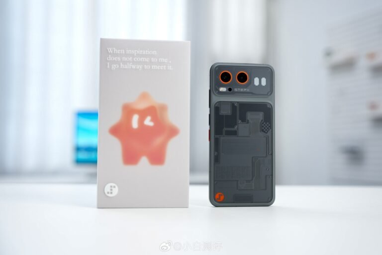 StepX Neo rear view in dark gray translucent finish showing circuit pattern design dual orange-ring camera lenses next to white retail box with orange star mascot