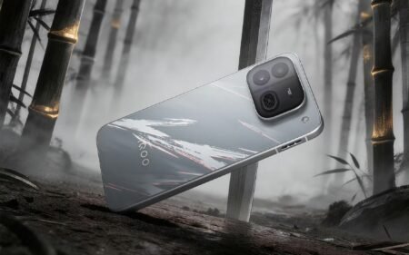 iQOO Neo 12 rear view in silver finish with brushstroke design, standing against misty bamboo background